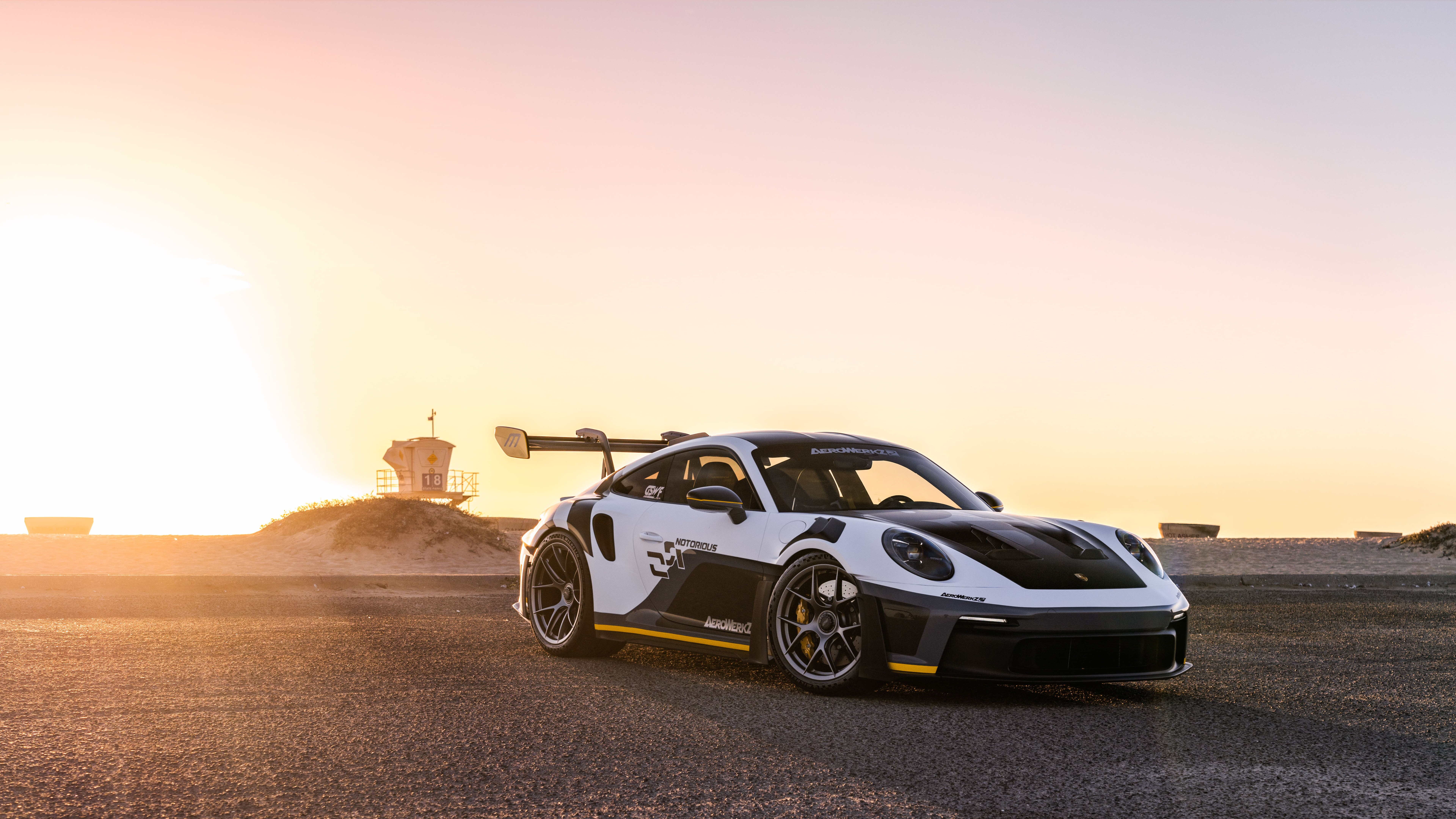 Un deportivo Porsche GT3 RS de alto rendimiento, con una carrocería de diseño aerodinámico y un alerón trasero de gran tamaño.